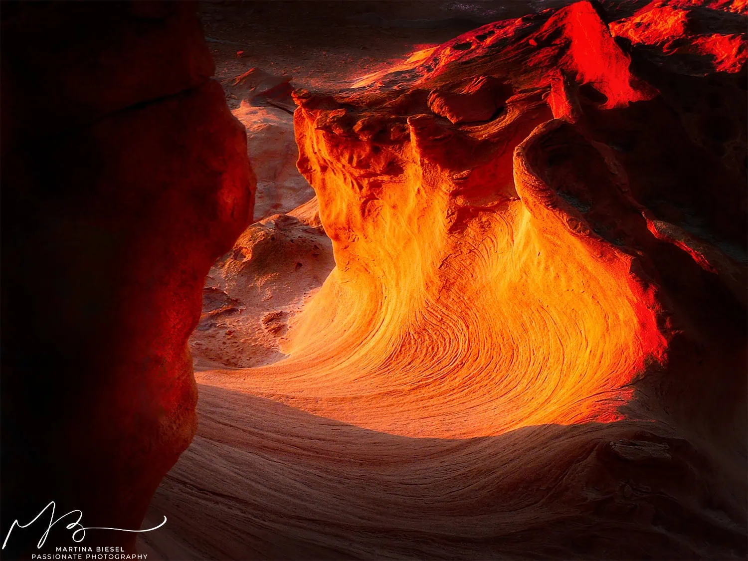 Little Finland: a red and orange sunset light is shining through a rocky wave.