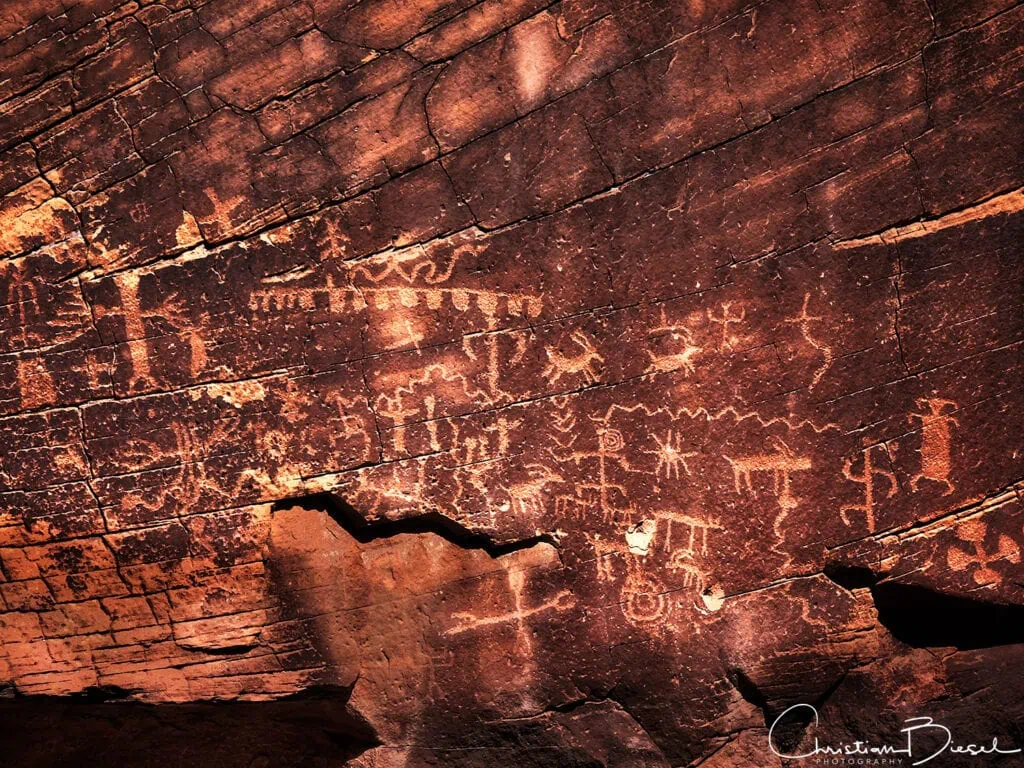 A rock with a lot of petroglyphs on it.